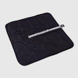 The waterproof nylon bottom of a My Place packable dog bed showing the closure strap and g hook