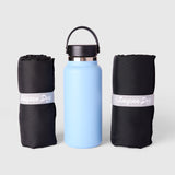 Two Layzee Dog My Place dog beds rolled up next to a water bottle