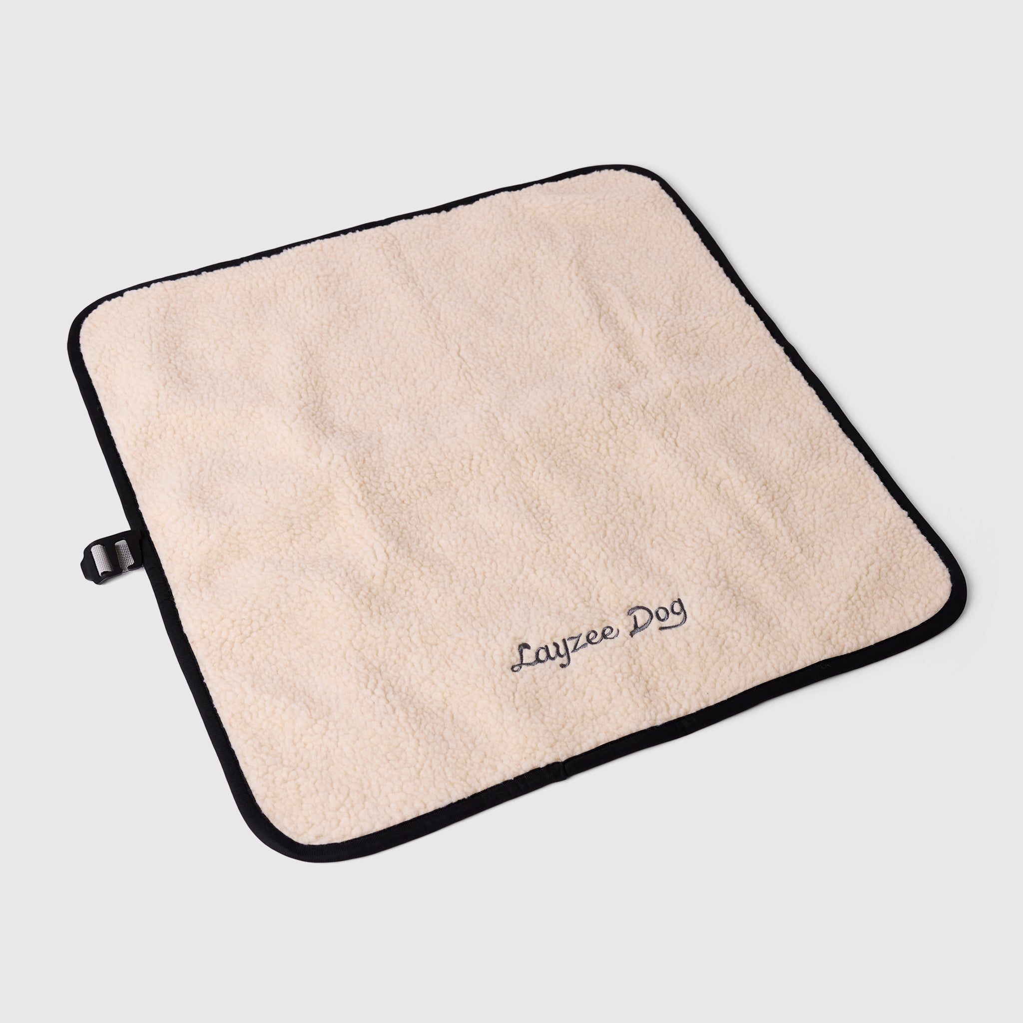A small My Place dog bed in creme brulee color on a light grey background