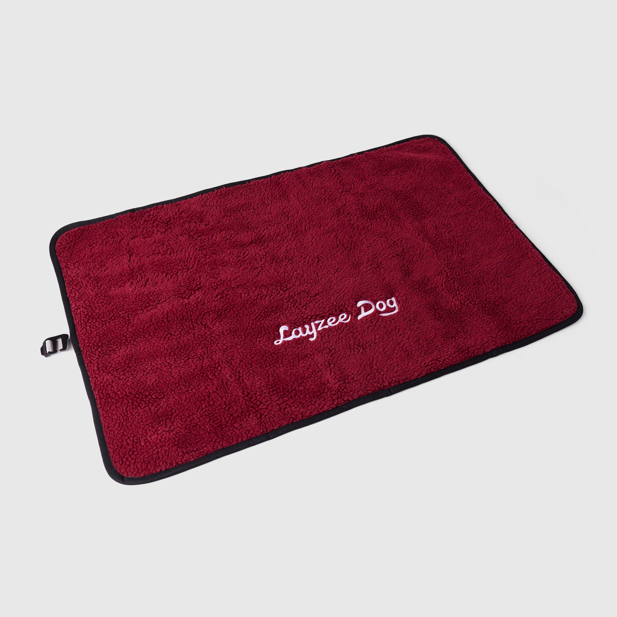 A large My Place dog bed in pinot noir color on a light grey background