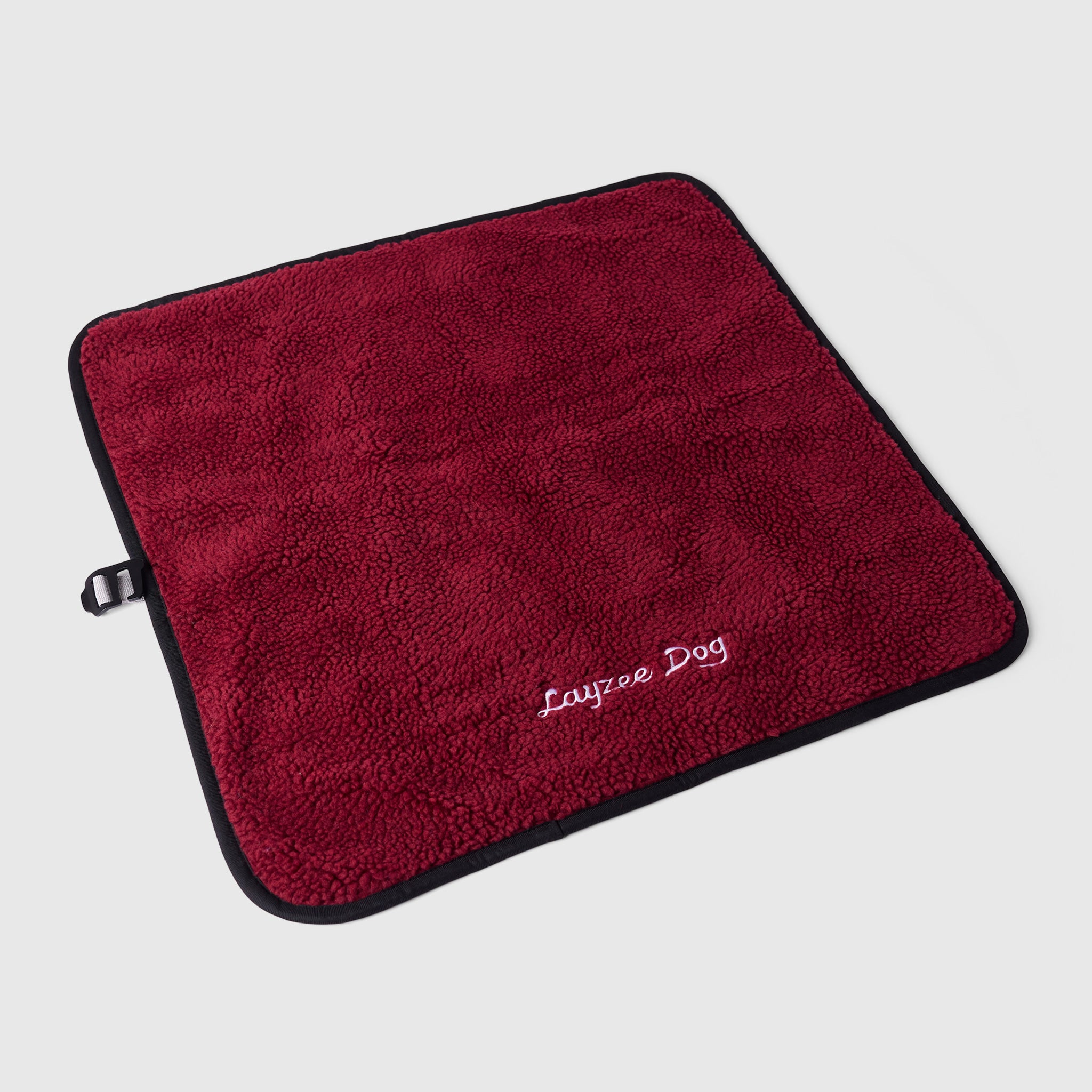A small My Place dog bed in pinot noir color on a light grey background